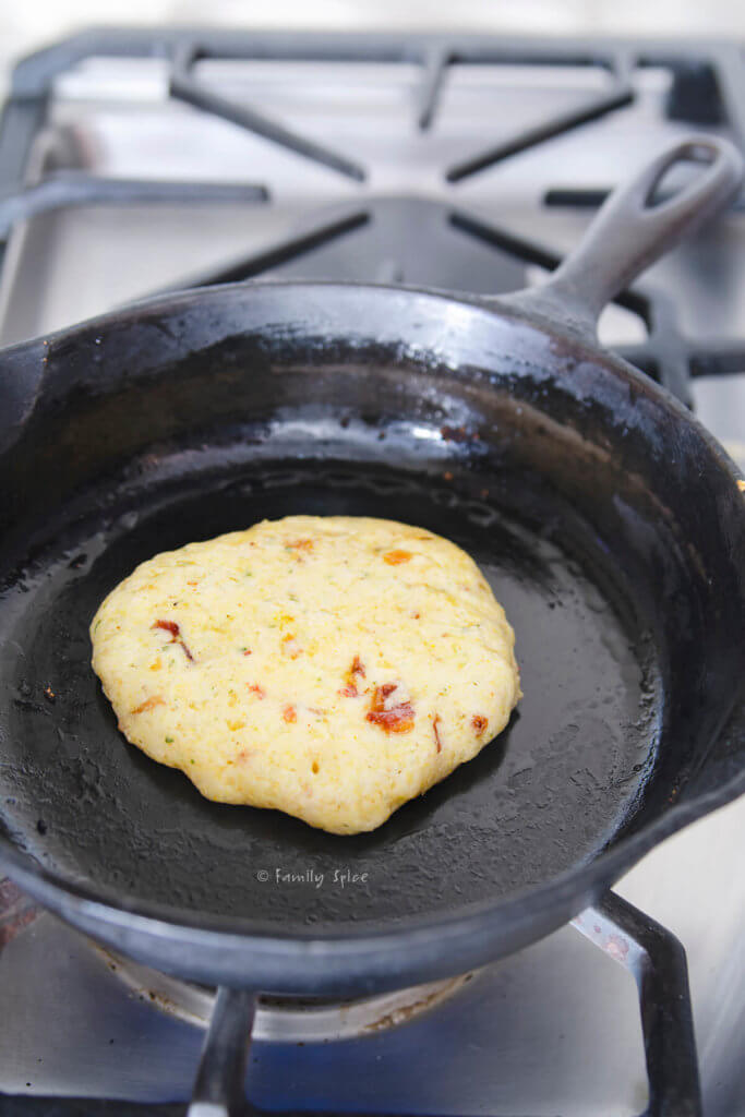 Cooking a cornbread pancake on a cast iron skillet