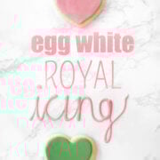 Two heart sugar cookies and words saying "egg white royal icing"