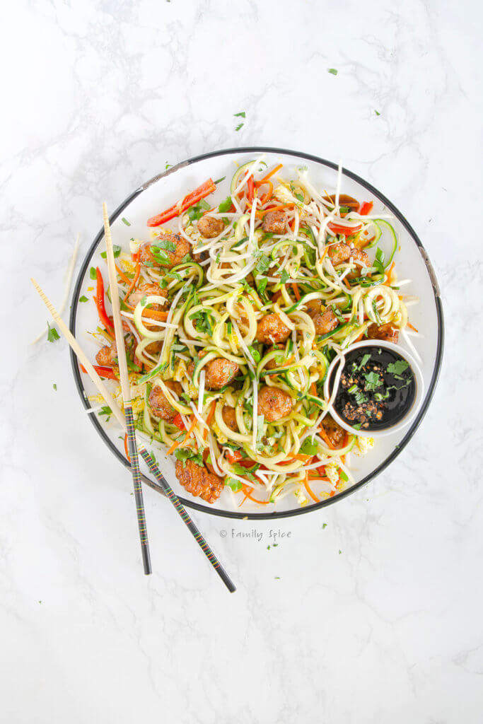 Overhead view of a large round platter with pad thai made with zucchini noodles
