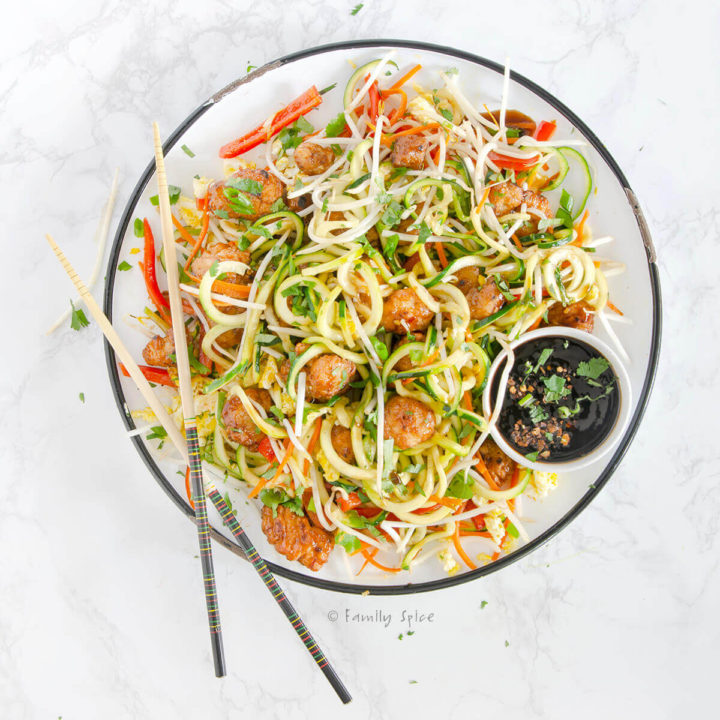 Overhead view of a large round platter with pad thai made with zucchini noodles