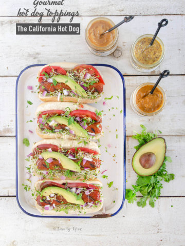 Gourmet hot dog toppings like avocado, tomato, sprouts, cilantro and red onions for the California Hot Dog