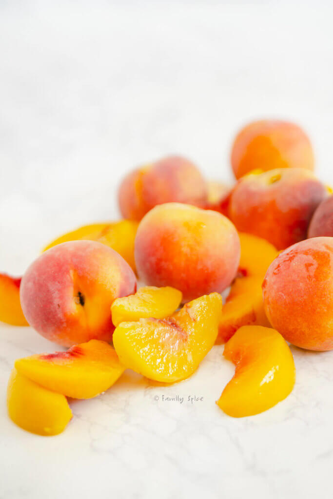 Whole peaches with sliced peaches piled together