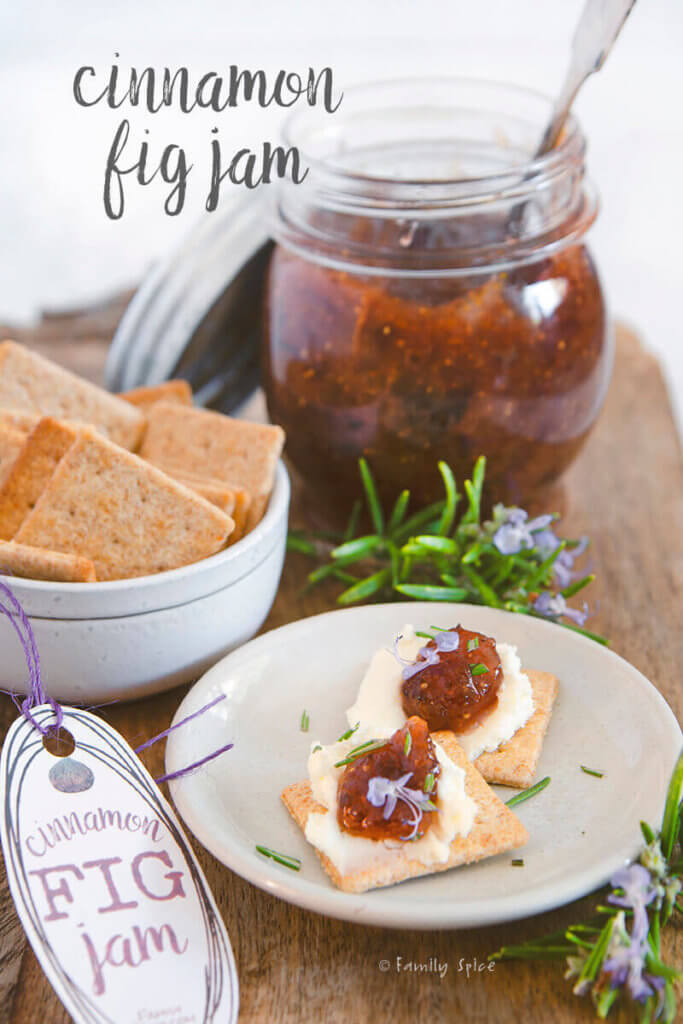 A small plate with crackers smeared with cheese and topped with cinnamon fig jam by FamilySpice.com