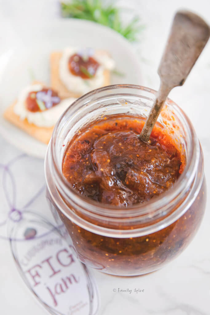 Top view of a jar of fig jam with a spoon in it