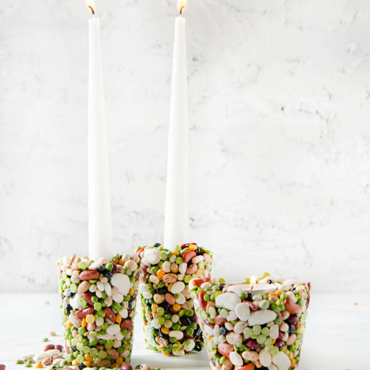 DIY candle holders made with beans on a white background