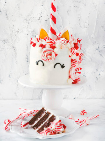 A chocolate peppermint unicorn cake with a slice of cake next to it