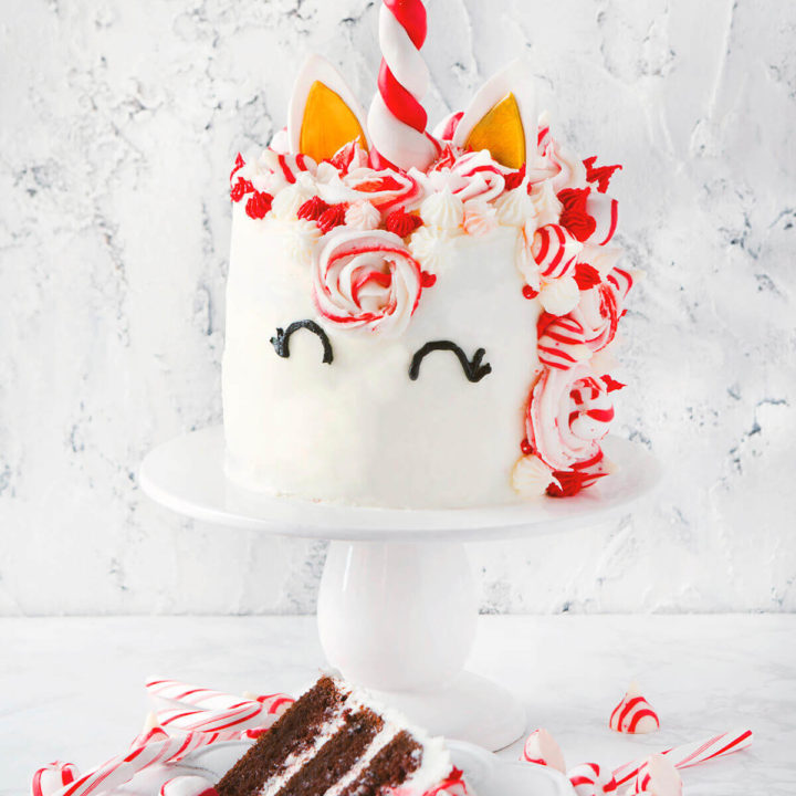 A chocolate peppermint unicorn cake with a slice of cake next to it