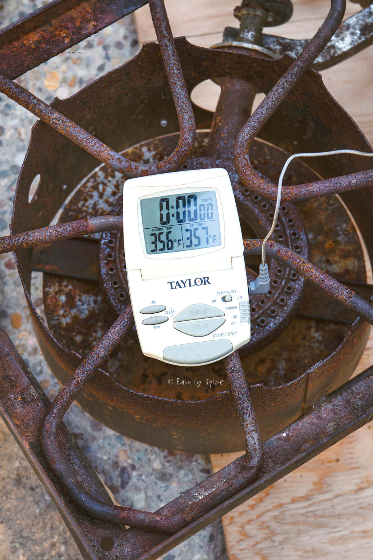 A meat thermometer showing the temperature of a deep fryer