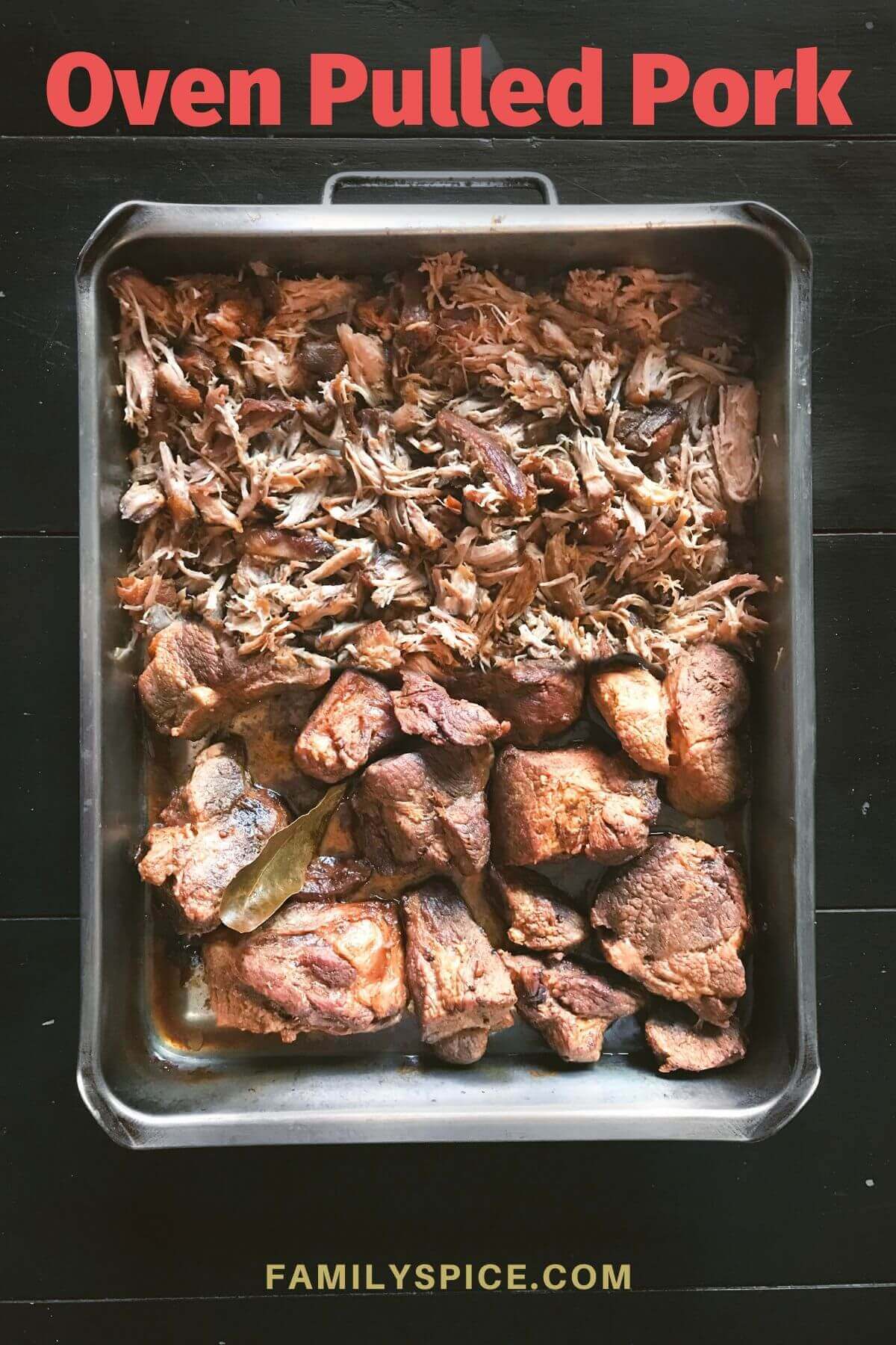 Shredding oven pulled pork in a roasting pan by FamilySpice.com