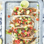 Pinterest image for pulled pork tacos in flour tortillas on a metal tray by FamilySpicecom