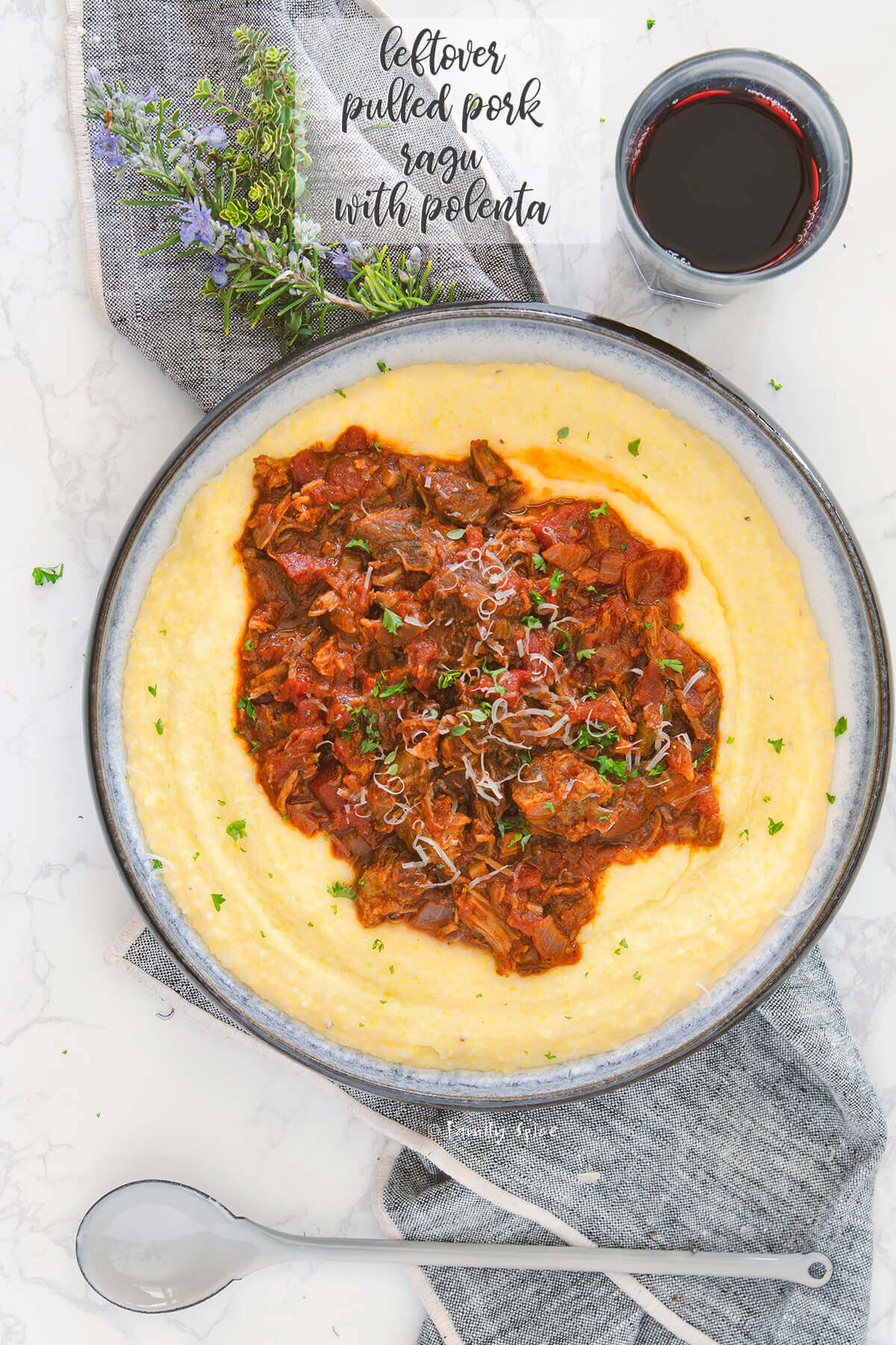 Overhead shot of a shallow bowl of polenta topped with pulled pork ragu by FamilySpice.com