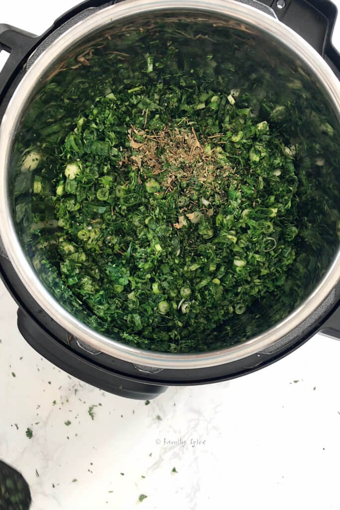Adding dried fenugreek into sautéed herbs in an instant pot