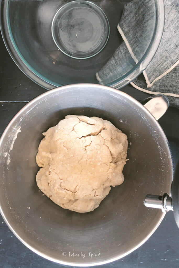 Whole wheat pretzel dough in the stainless bowl of a stand mixer