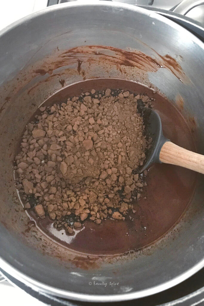 cocoa powder and melted chocolate in a double boiler to make chocolate cake