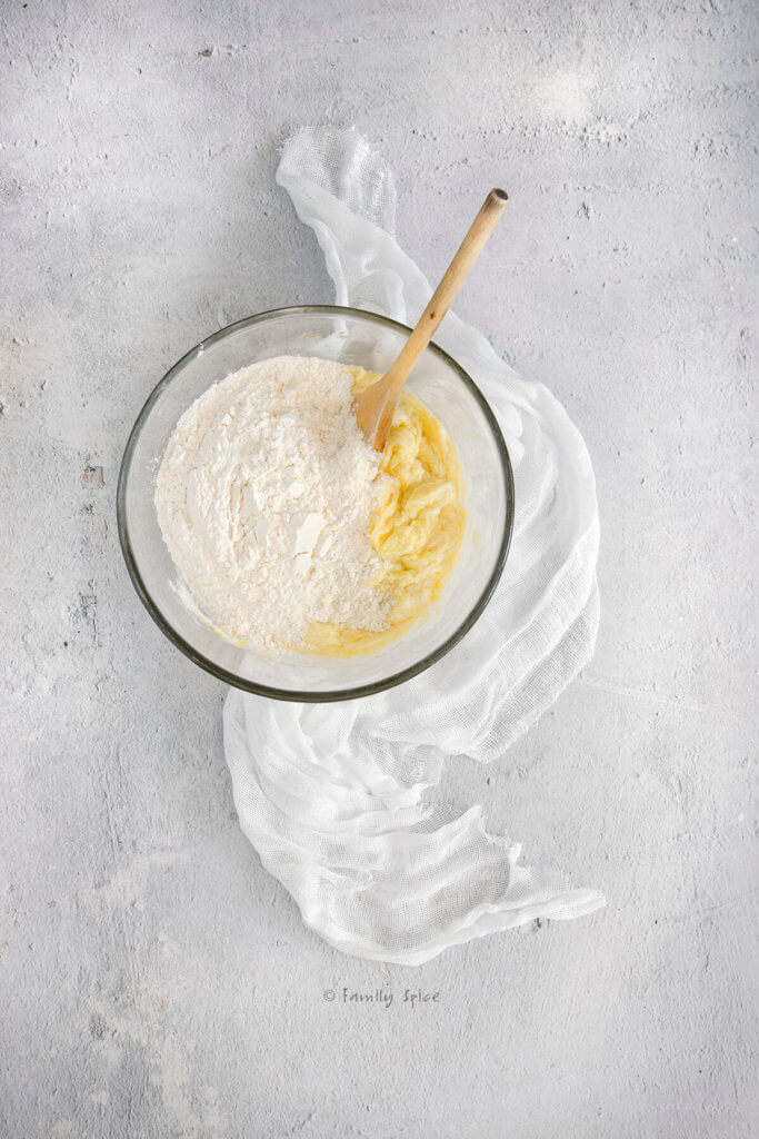 Adding flour to creamed butter mixture
