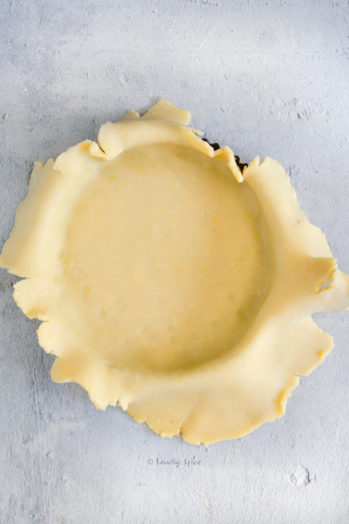 Pie dough placed over a tart pan