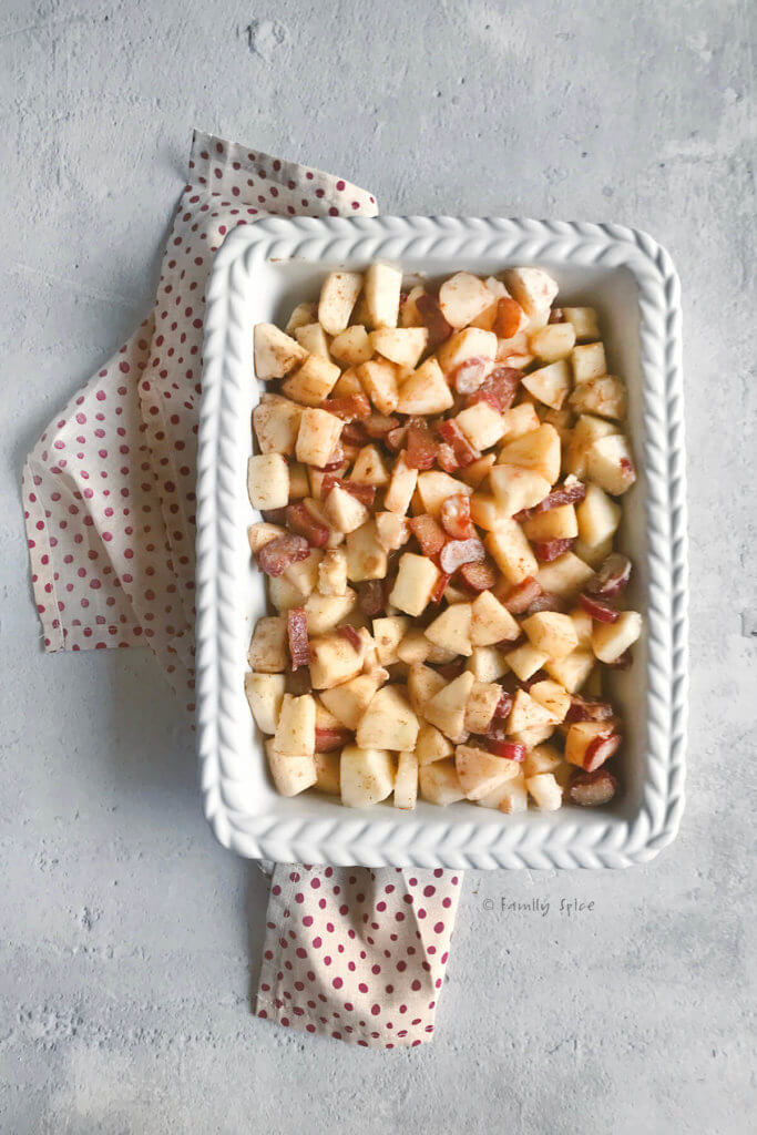 A white rectangle baking dish with chopped apples and rhubarb