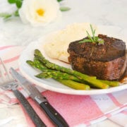 A plate with filet mignon, asparagus and mashed potatoes