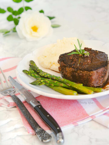 A plate with filet mignon, asparagus and mashed potatoes