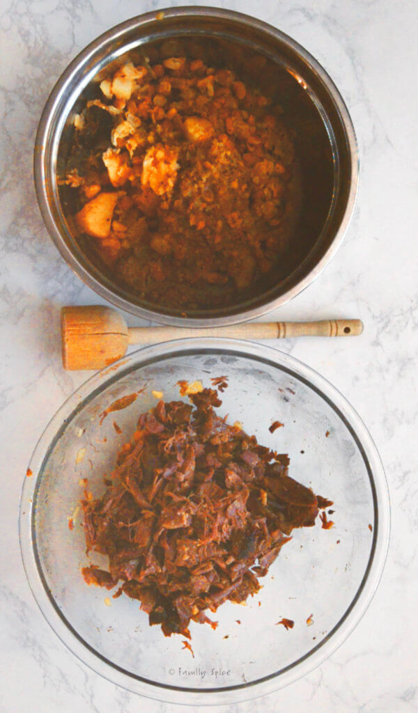 One bowl with shredded meat and another bowl with remaining cooked ingredients for abgoosht