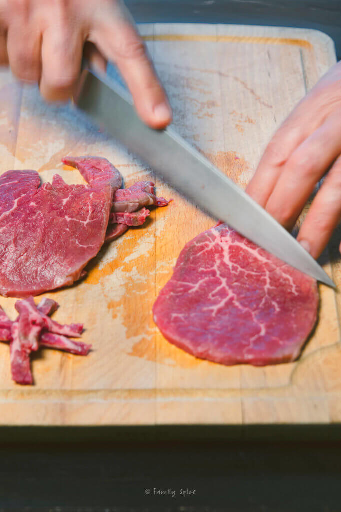 Removing fat from slices of meat for oven beef jerky