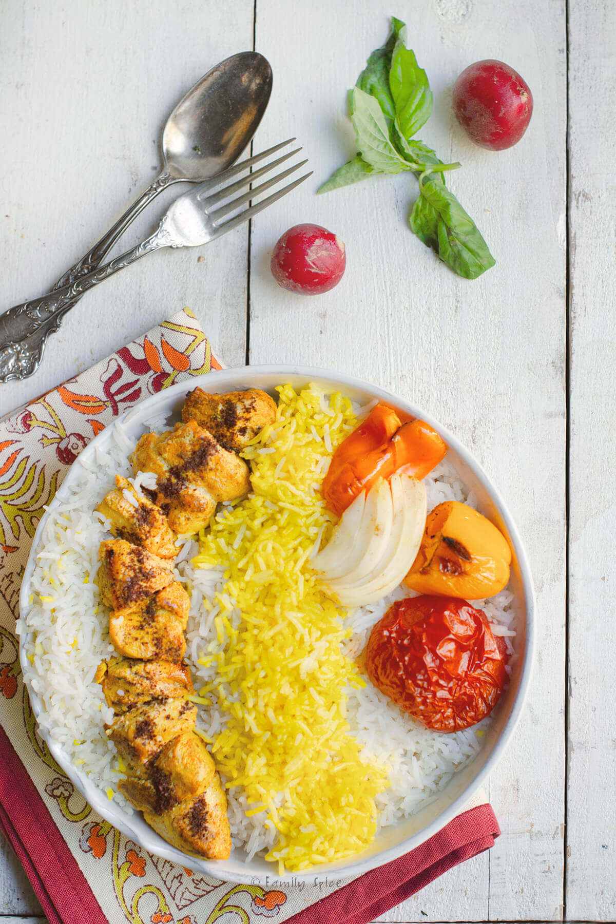 Closer view Persian chicken kebab with basmati rice, grilled tomato, onion and peppers