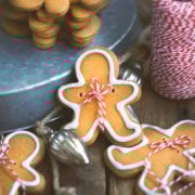 Closeup of a gingerbread man cookie with baker's twine tied around it