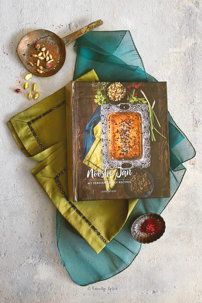 Picture of my persian cookbook that I created and printed online with various ingredients around it