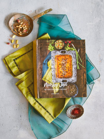 Picture of my persian cookbook that I created and printed online with various ingredients around it