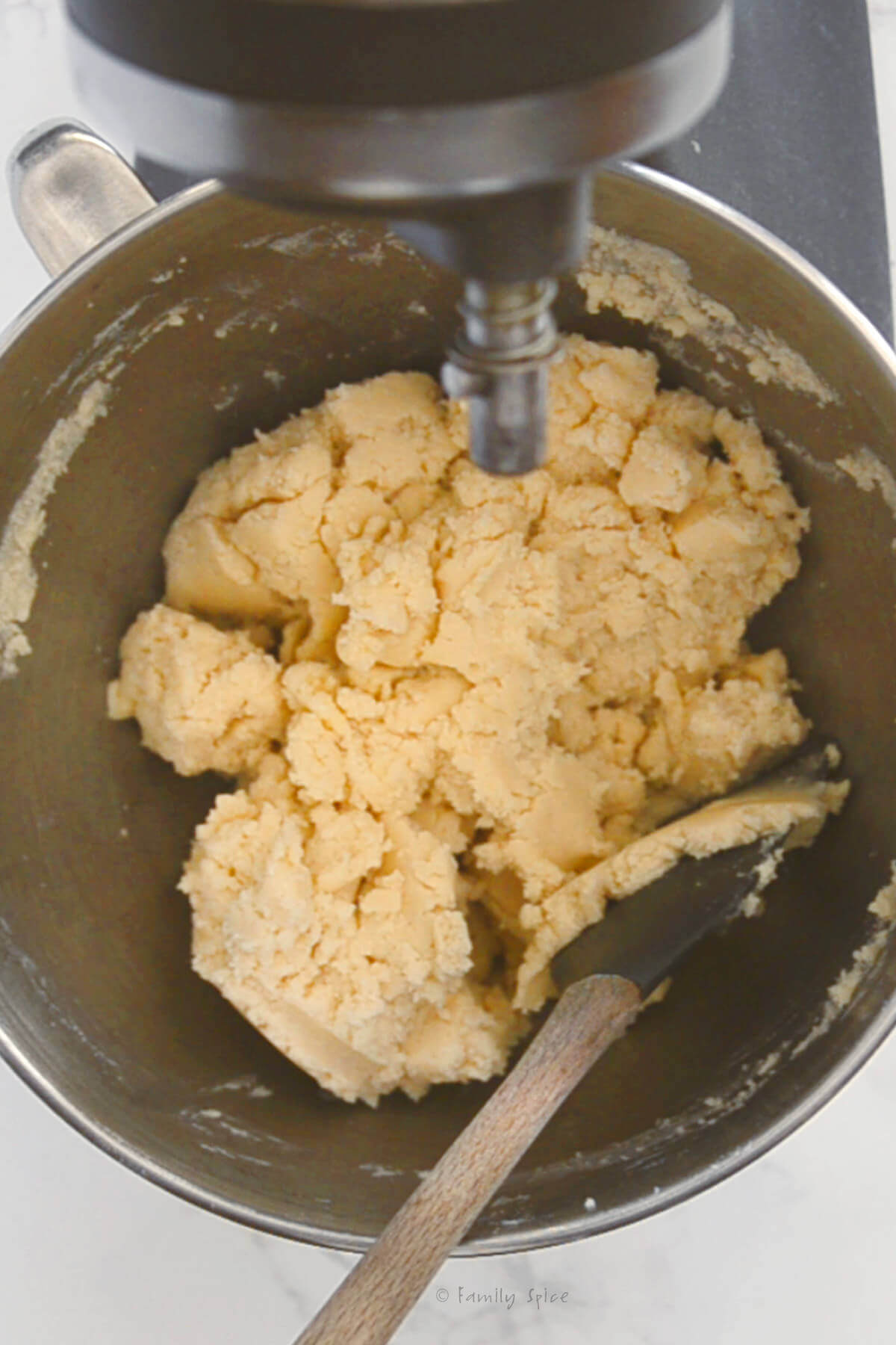 Sugar cookie dough mixed in a metal mixing bowl