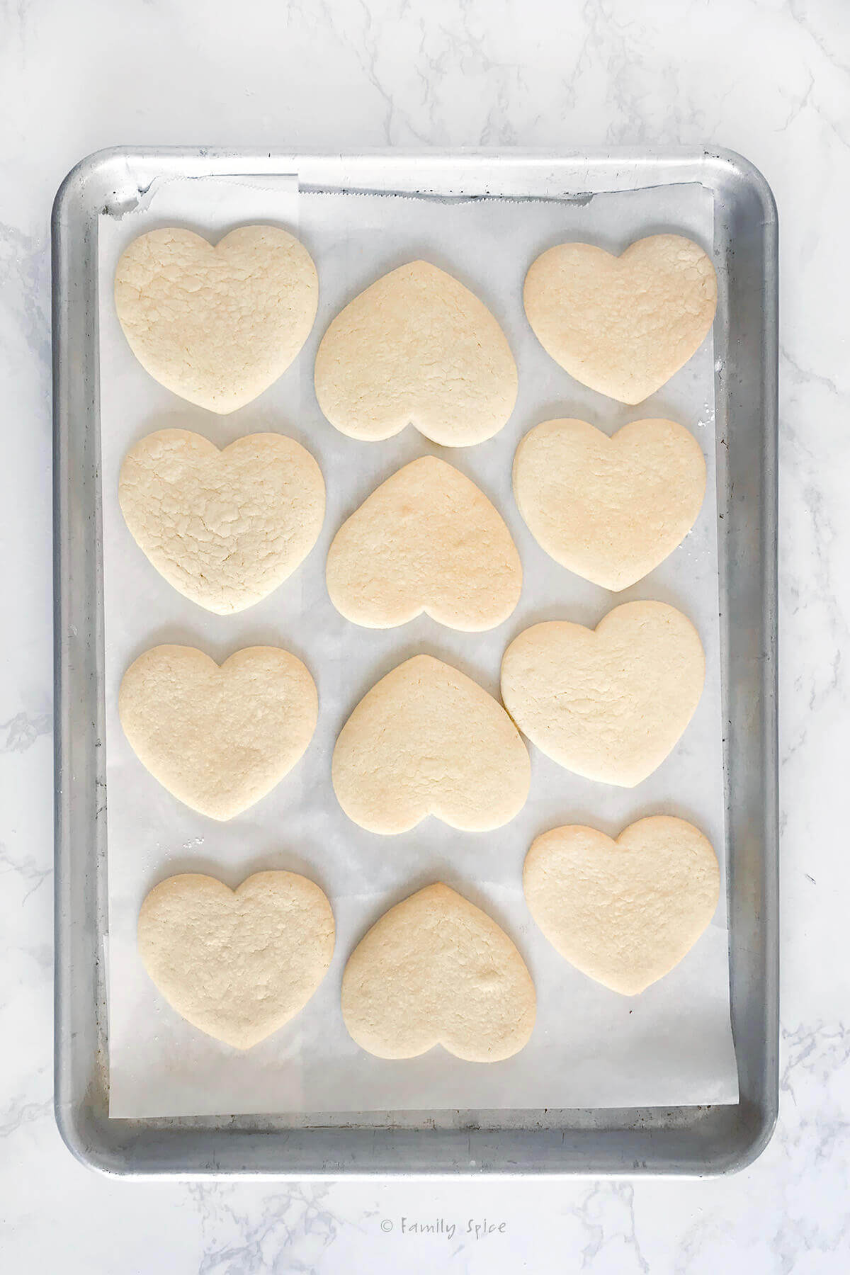 A baking sheet with heart cookies baked on it