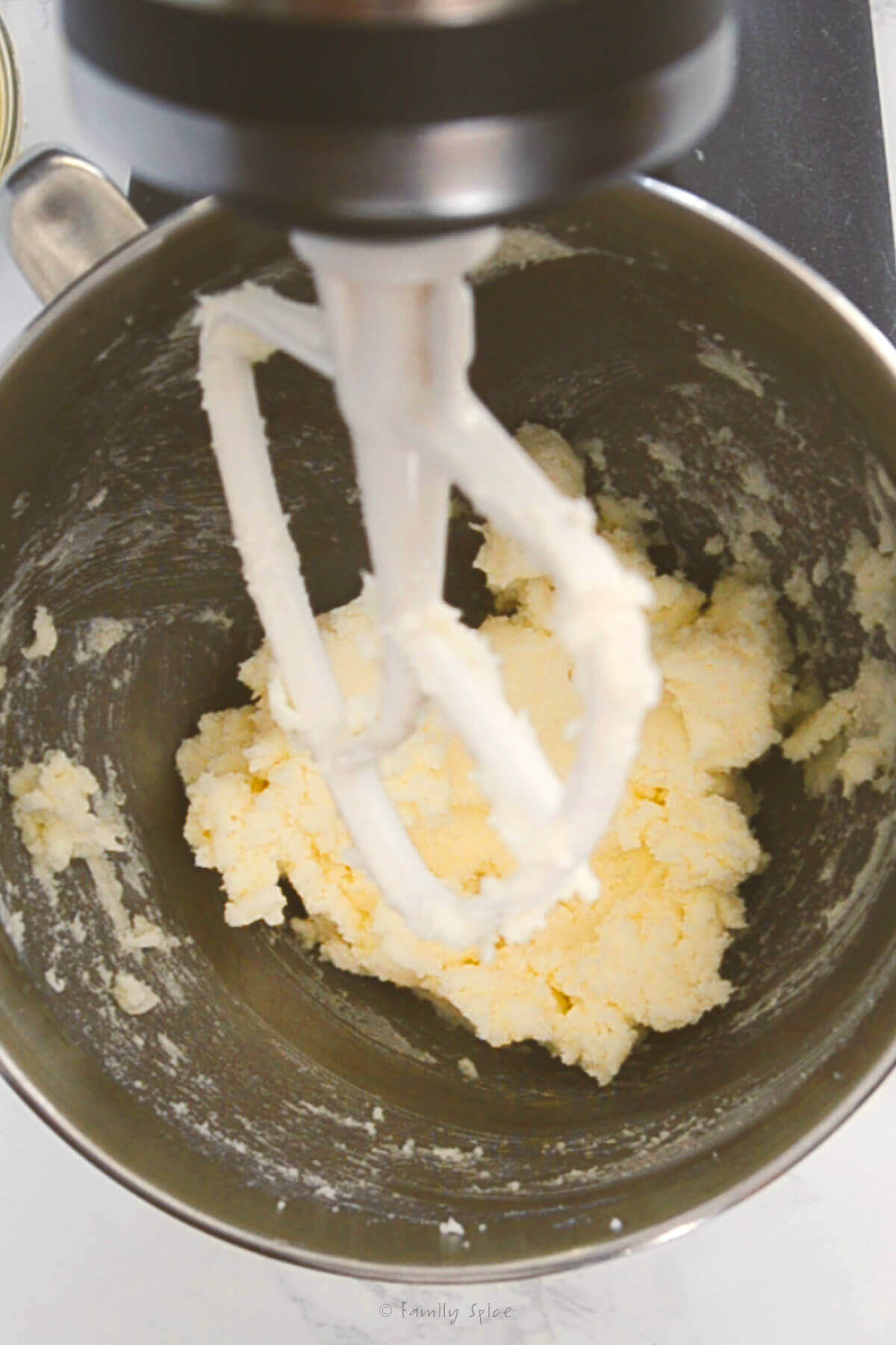 A mixer mixing up sugar cookie dough