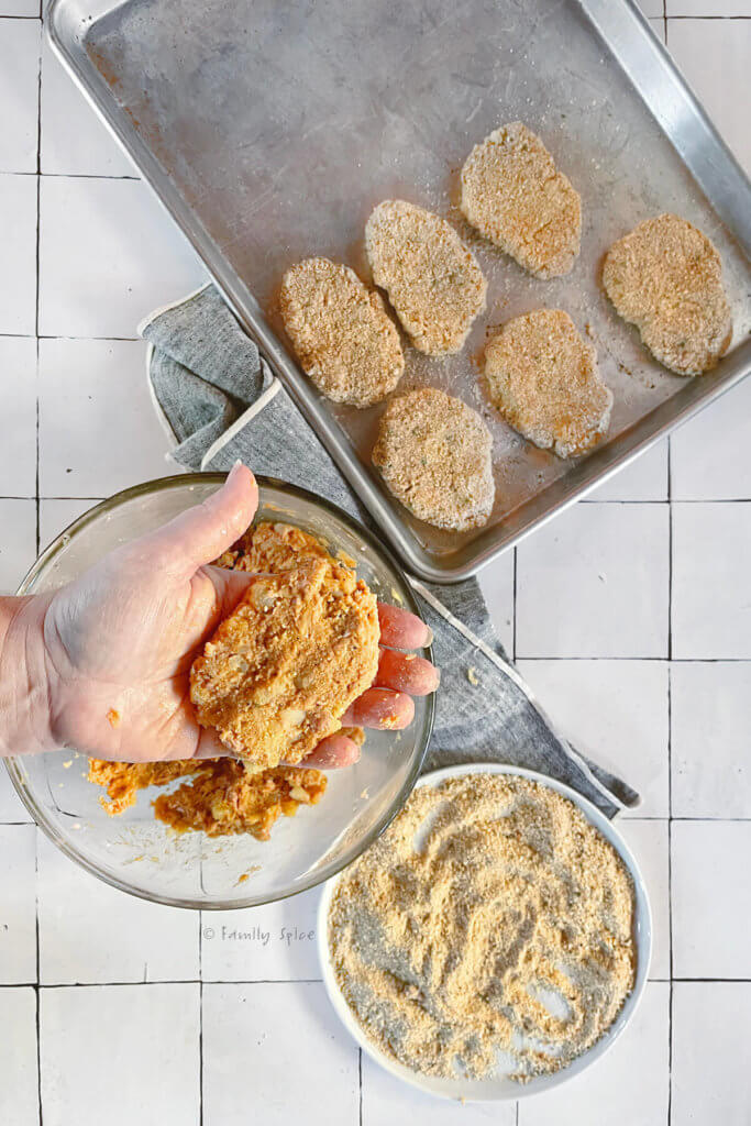 A hand holding a raw ground turkey kotlet showing how to prepare it