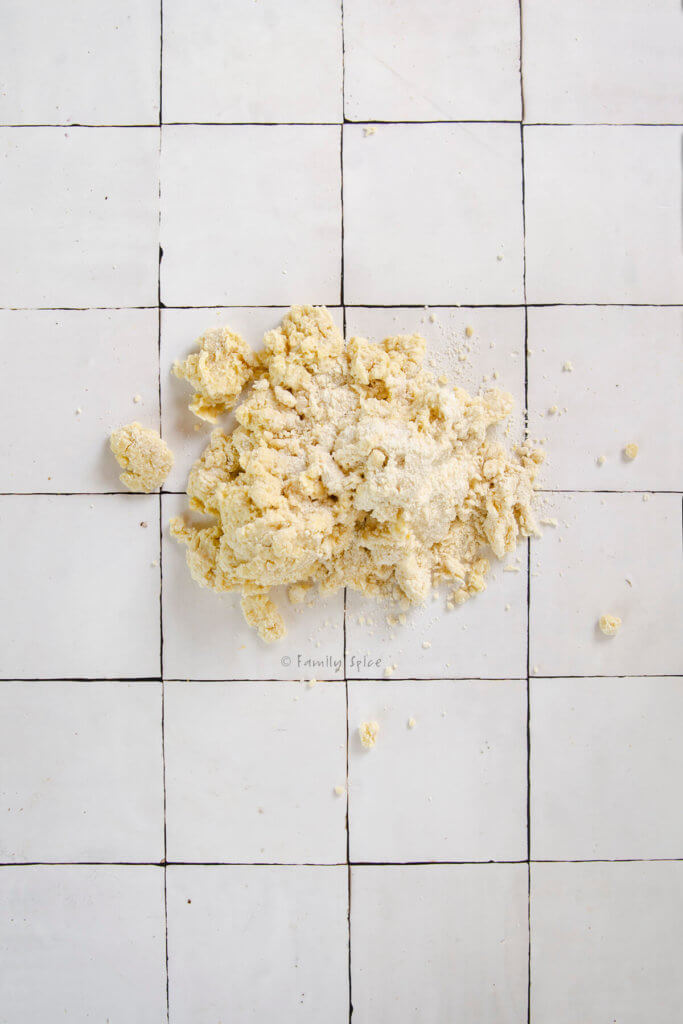 Rough sour cream scone dough turned onto a white tile counter