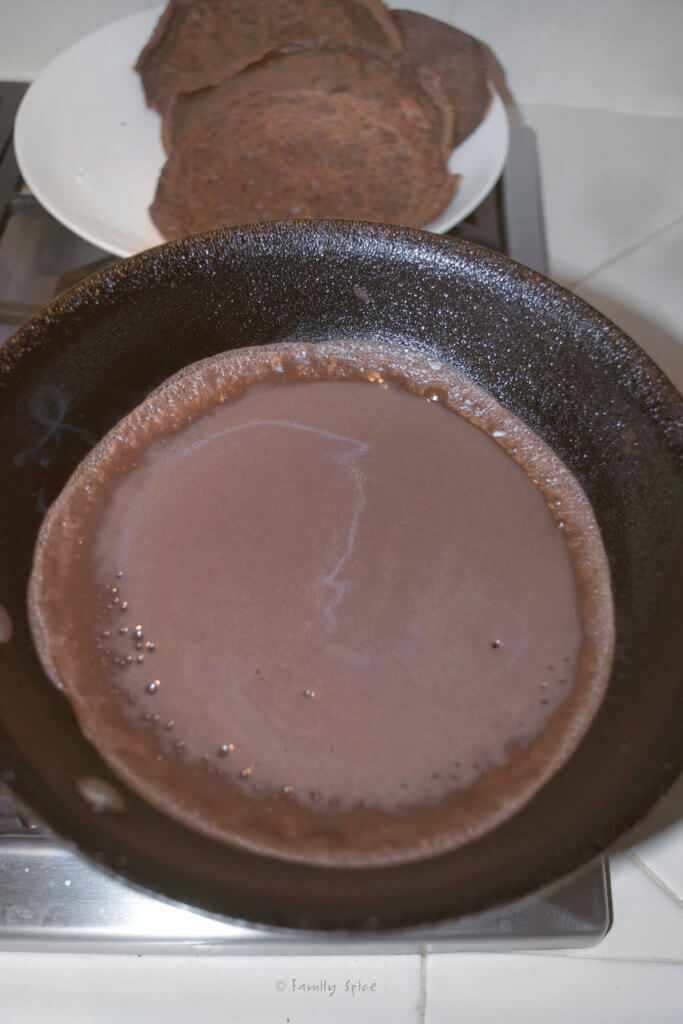 Cooking and swirling chocolate crepe batter in a nonstick pan