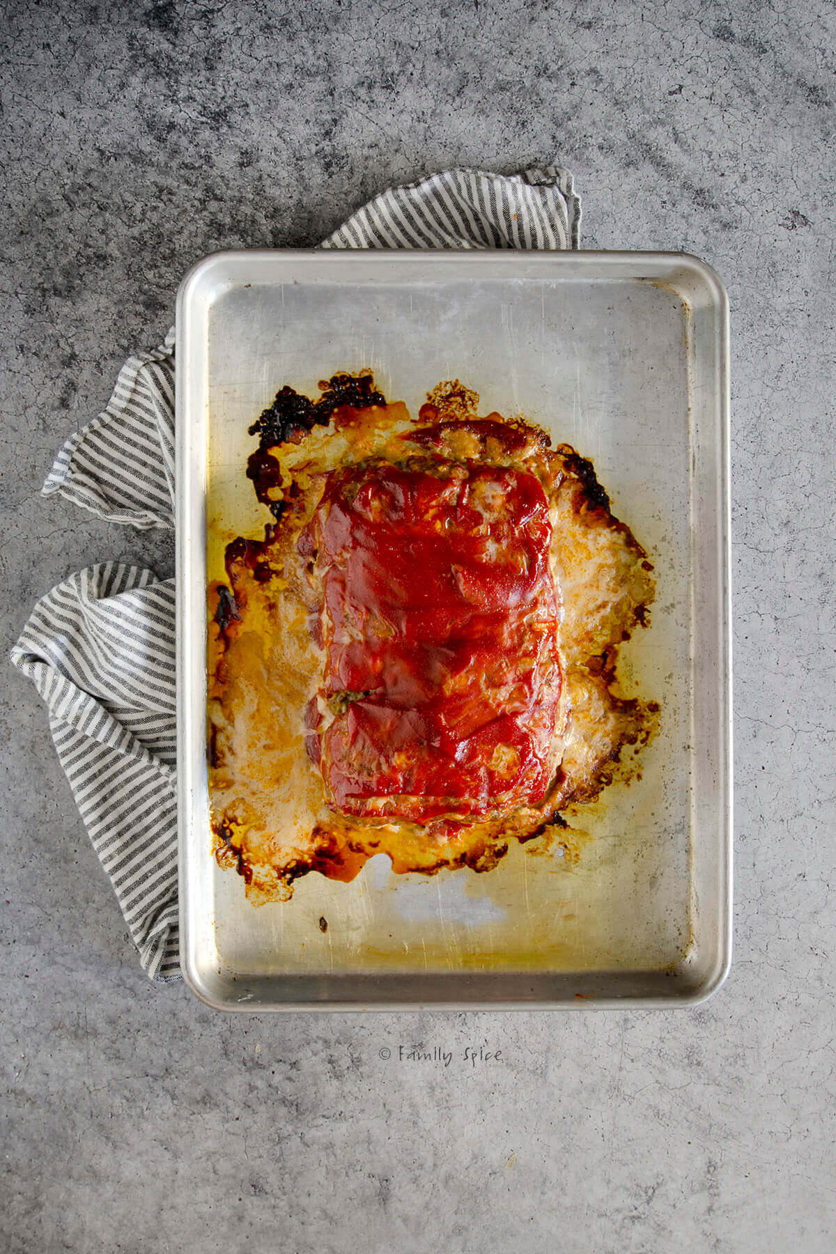 A meatloaf freshly baked on a baking sheet