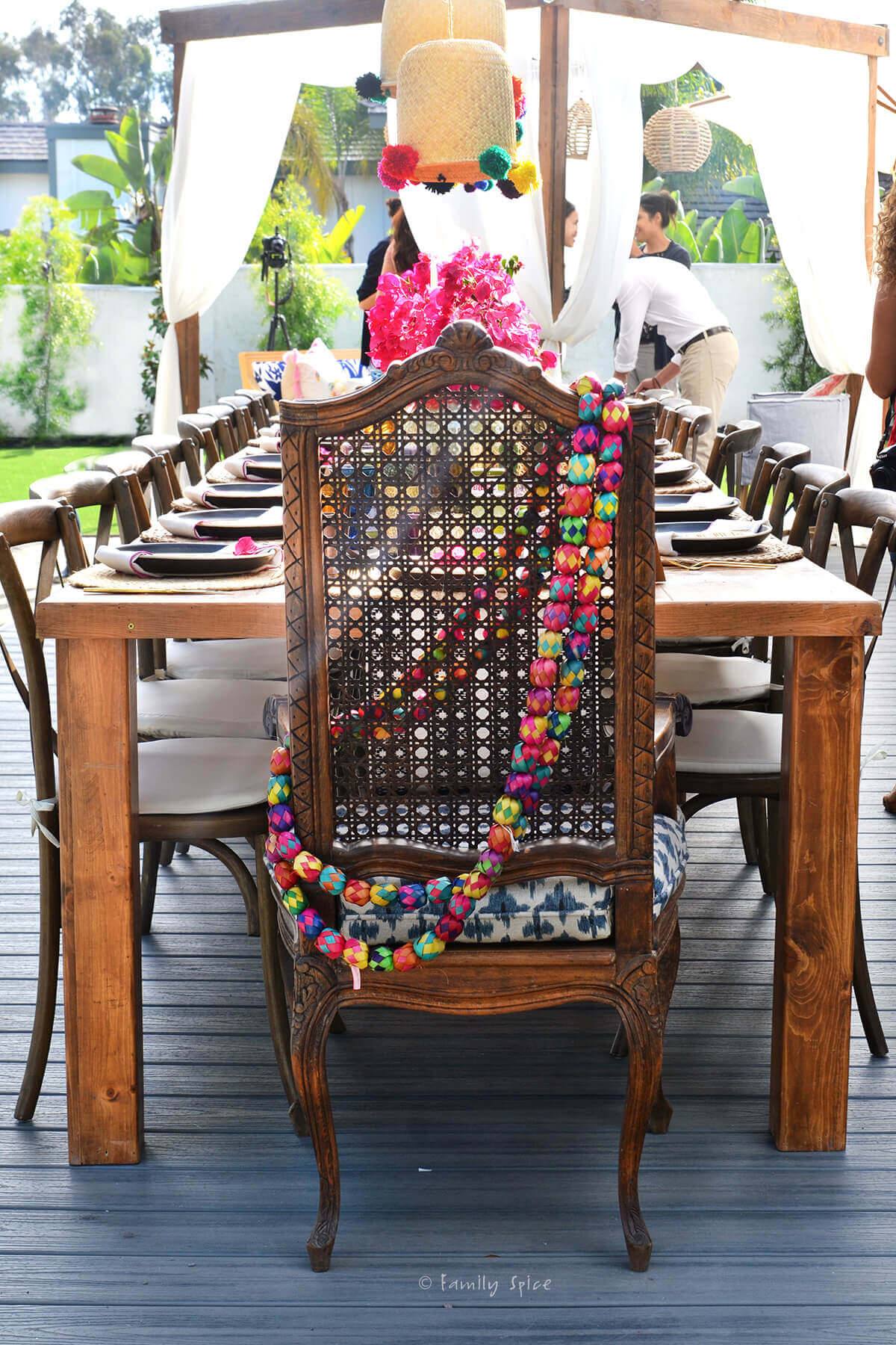 A decorated dining table setup outside with Mexican embellishments