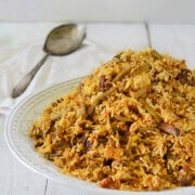 A large round platter with lubia polo (green bean rice) piled in it
