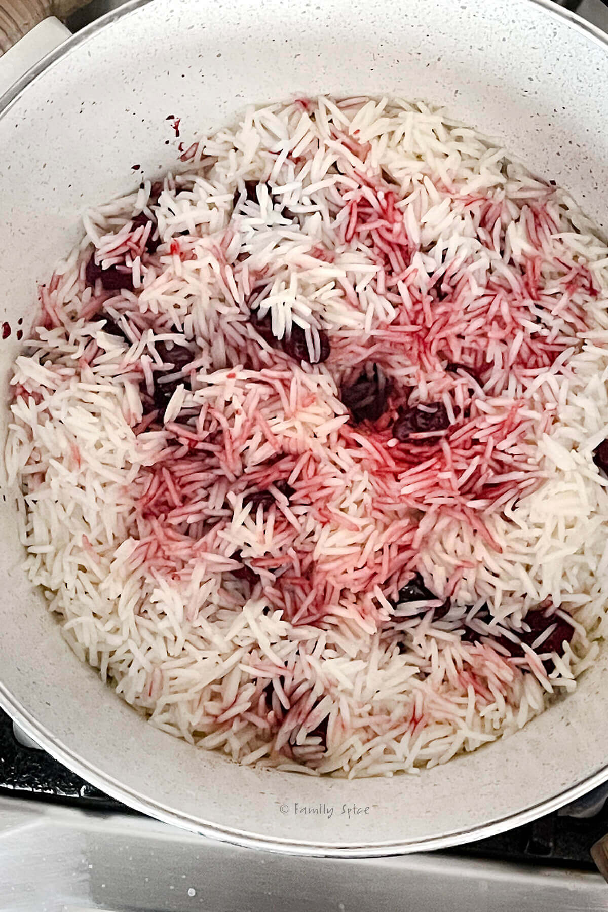 More layers of basmati rice, sour cherries and syrup in a pot