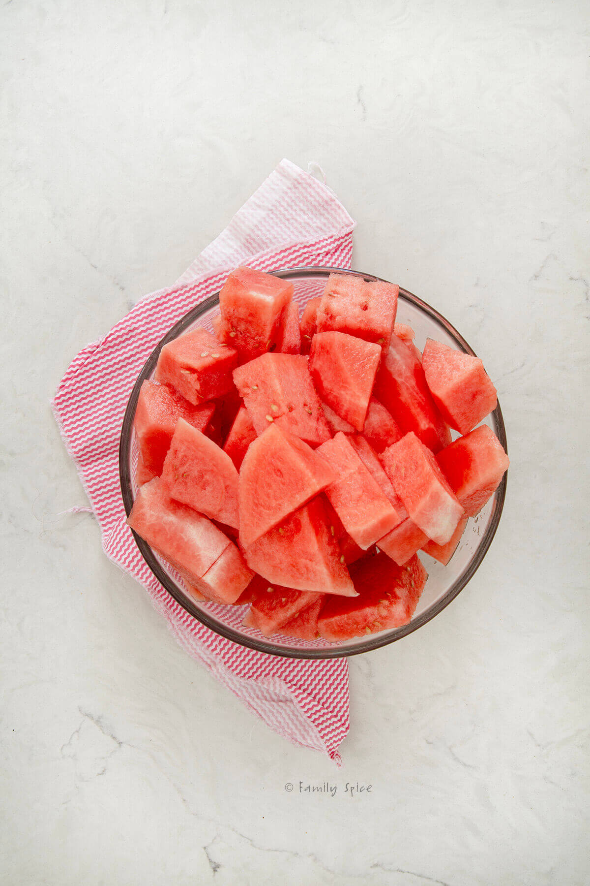 A bowl filled with cut up pieces of watermelon