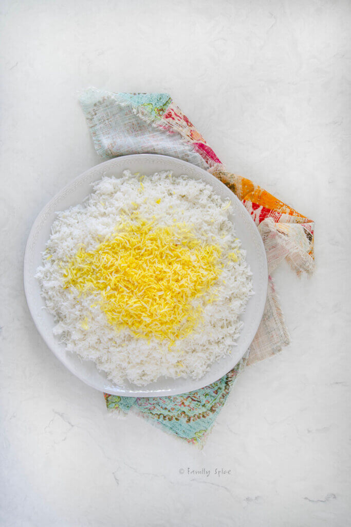 Top view of a round platter with Persian rice topped with saffron rice