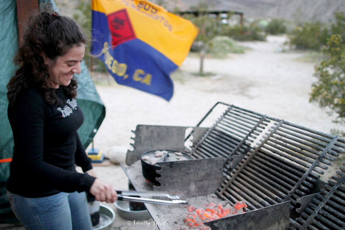 Laura Bashar at a campground cooking with Dutch ovens and hot coals