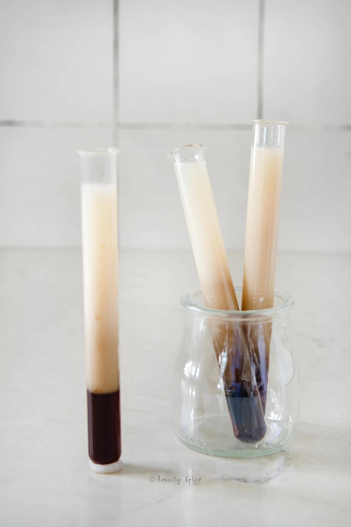 Closeup of three test tubes that hold B52 drinks.