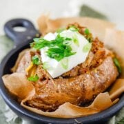 Pinterest image for pulled pork baked potatoes.